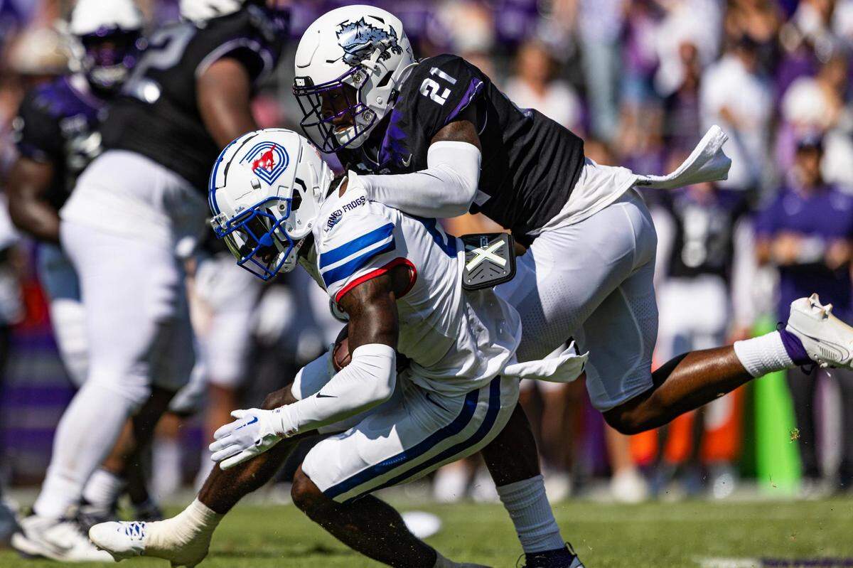 TCU safety Bud Clark (21) makes a tackle in the first half of a college football game between the TCU Horned Frogs and the SMU Mustangs at Amon G. Carter Stadium in Fort Worth on Saturday, Sept. 23, 2023.