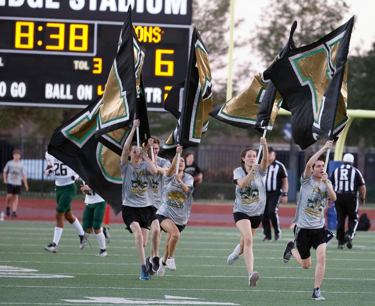 The Birdville flag crew runs the field after a Hawks touchdown in the first half of a UIL football game at Standridge Stadium in Carrollton, Texas, Thursday Sept. 07, 2023. Birdville led 27-12 at the half. (Special to the Star-Telegram Bob Booth)