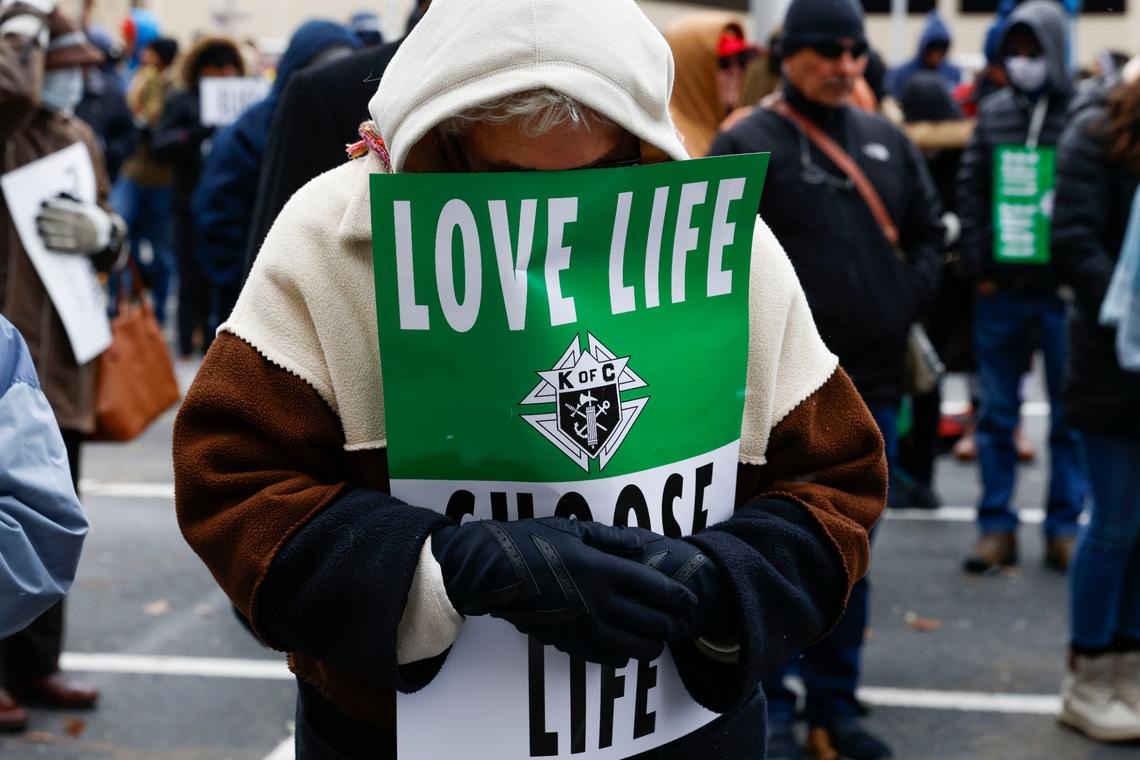 FILE - A marcher prays ahead of the North Texas March for Life, celebrating the passage and court rulings upholding the Texas law known as Senate Bill 8, on Saturday, Jan. 15, 2022, in Dallas. Abortion isn’t taking center stage in Texas’ first-in-the-nation primary. The March 1, 2022 primary will mark six months that Texas clinics have operated under a law that bans abortion after roughly six weeks of pregnancy. (Shafkat Anowar/The Dallas Morning News via AP, File)