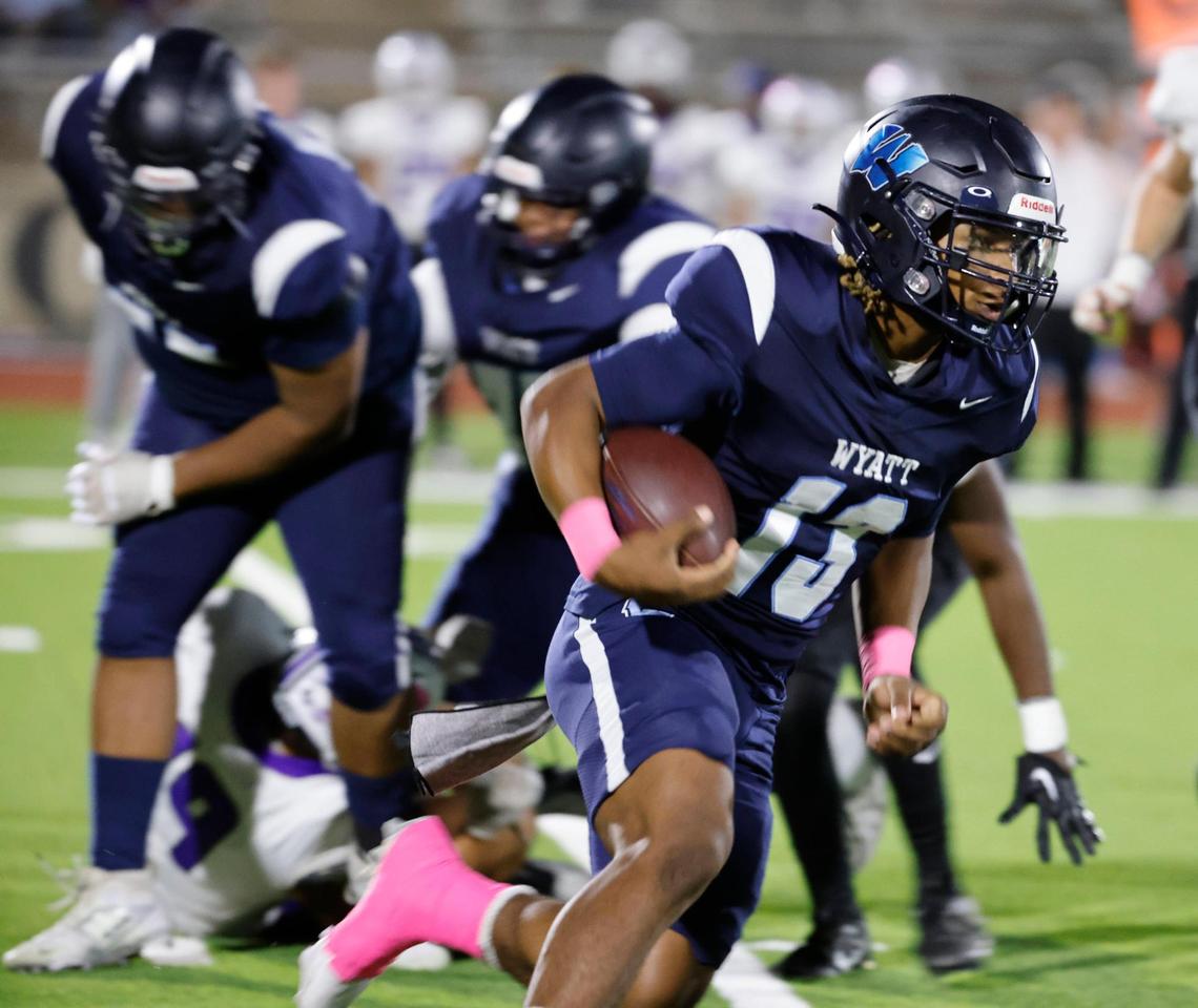 Wyatt quarterback Jorvorskie Lane (13) runs the ball on a keeper around the right side during a District 4-5A Division 1 football game at Herman Clark Stadium in Fort Worth, Texas, Thursday, Oct. 24, 2024.