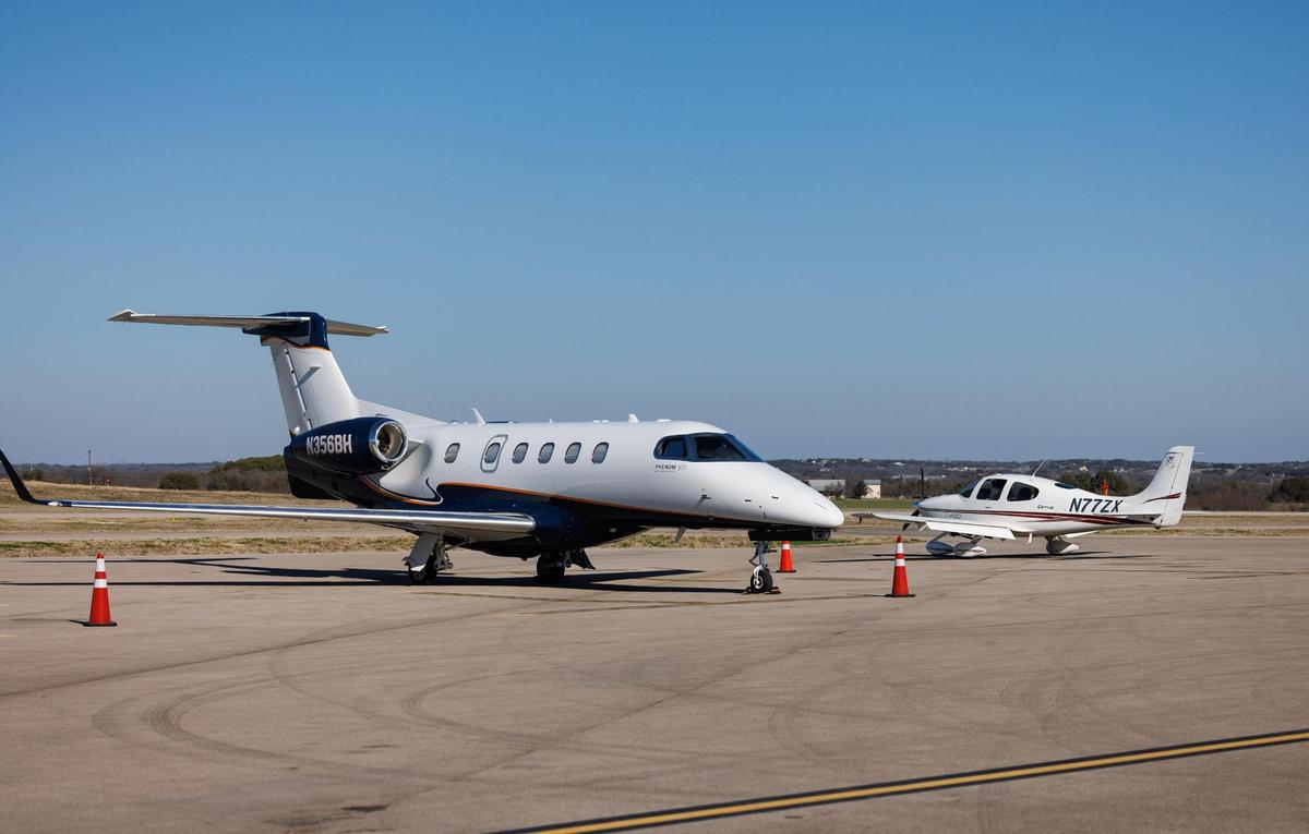 A Embraer Phenom 300, left, is parked next to a Cirrus SR20 at the Granbury Regional Airport on Wednesday, Feb. 26, 2025. The airport recently opened a new, longer runway that allows for larger aircraft, such as the Phenom 300, land there.