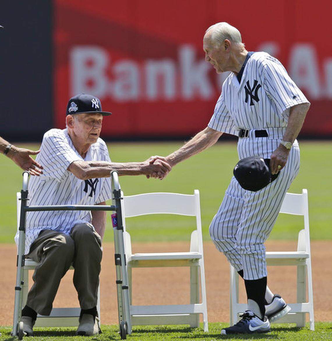 Former New York Yankees Bobby Brown, right, shakes hands with Don Larson during Old-Timers’ Day at Yankee Stadium, Sunday, June 25, 2017, in New York. (AP Photo/Seth Wenig)