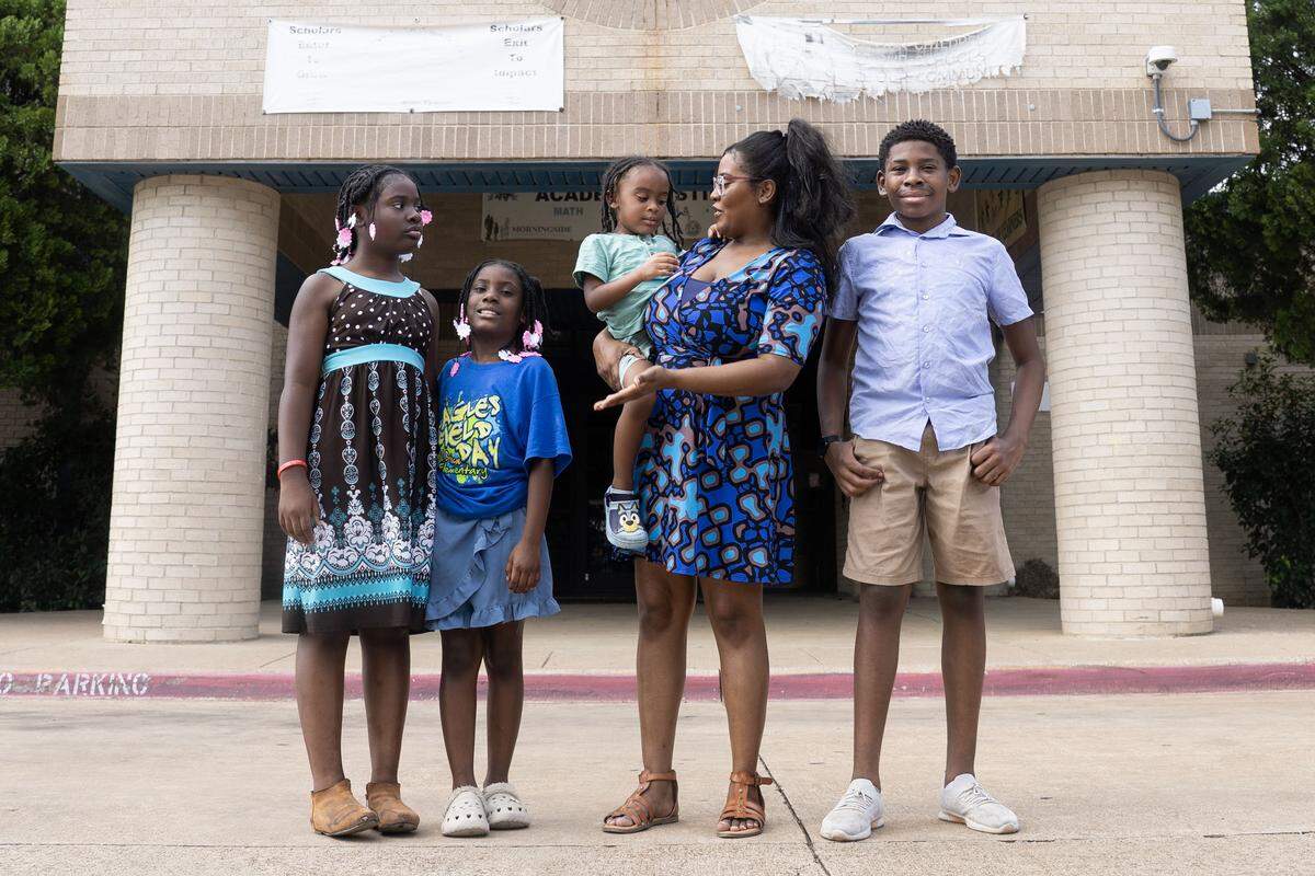 Briscoe Elementary parent Toyneisha Lomax is photographed with her kids Moriah, 10, Aniyah, 8, Gabriel, 4, and Deshawn, 13, in front of Briscoe Elementary School in Fort Worth on Saturday, July 12, 2025. Briscoe is one of the multiple Fort Worth ISD schools chosen to close within the next few years.