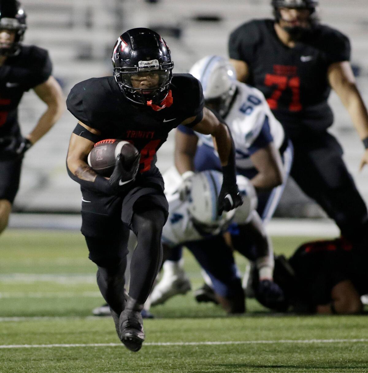 Trinity’s Josh Bell heads down the field for a touchdown during a UIL football game at Pennington Field on Thursday, November 7, 2024.