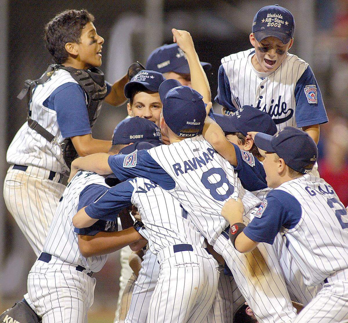 Southwestern Region Championship featuring the Fort Worth Westside Lions vs the Sugar Land, Texas First Colony little league teams at Marvin Norcross Stadium in Waco, Texas on Sunday August 11, 2002. Fort Worth’s Westside Lion’s celebrate their victory, defeating Sugar Land 2-0.