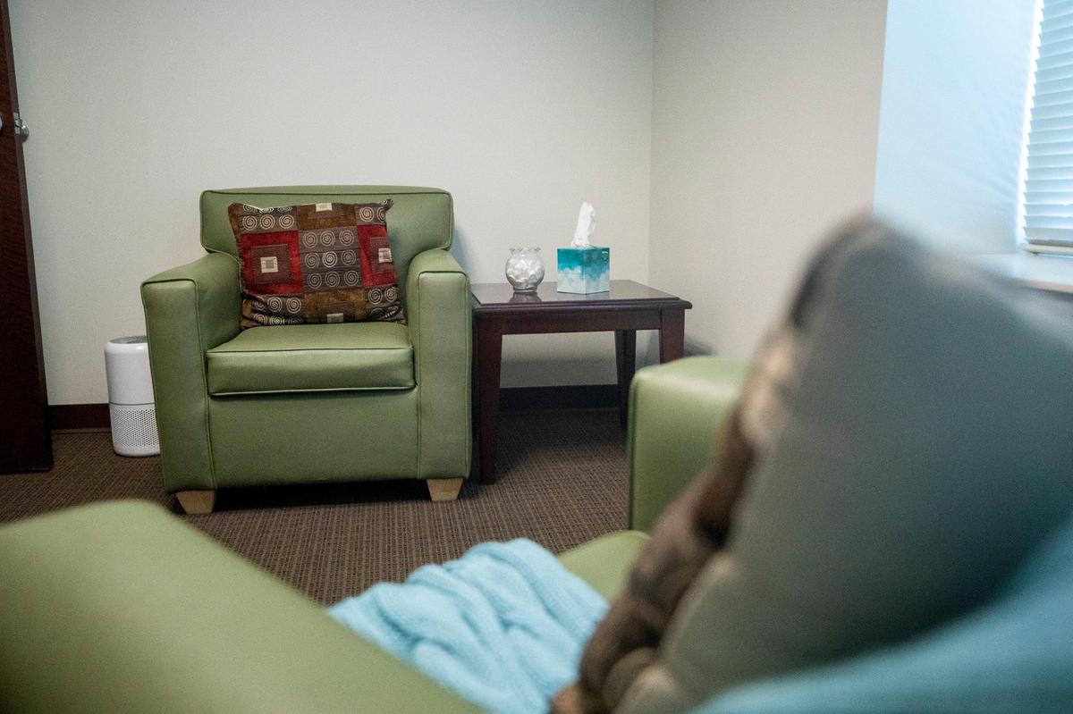 An image of an empty room with two arm chairs.