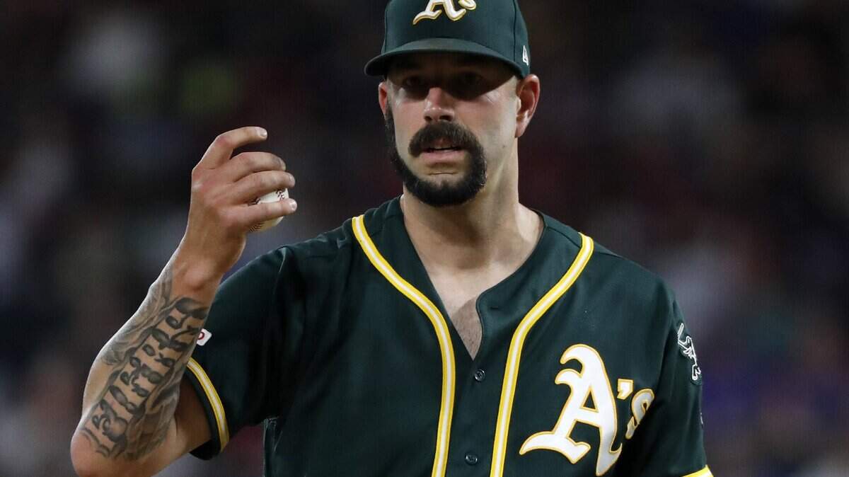 Oakland Athletics starting pitcher Mike Fiers looks at manager Bob Melvin and staff walking out to the mound to pull him in the second inning of a baseball game against the Texas Rangers in Arlington, Texas, Saturday, Sept. 14, 2019. Fiers left the game with an unknown injury. (AP Photo/Tony Gutierrez)
