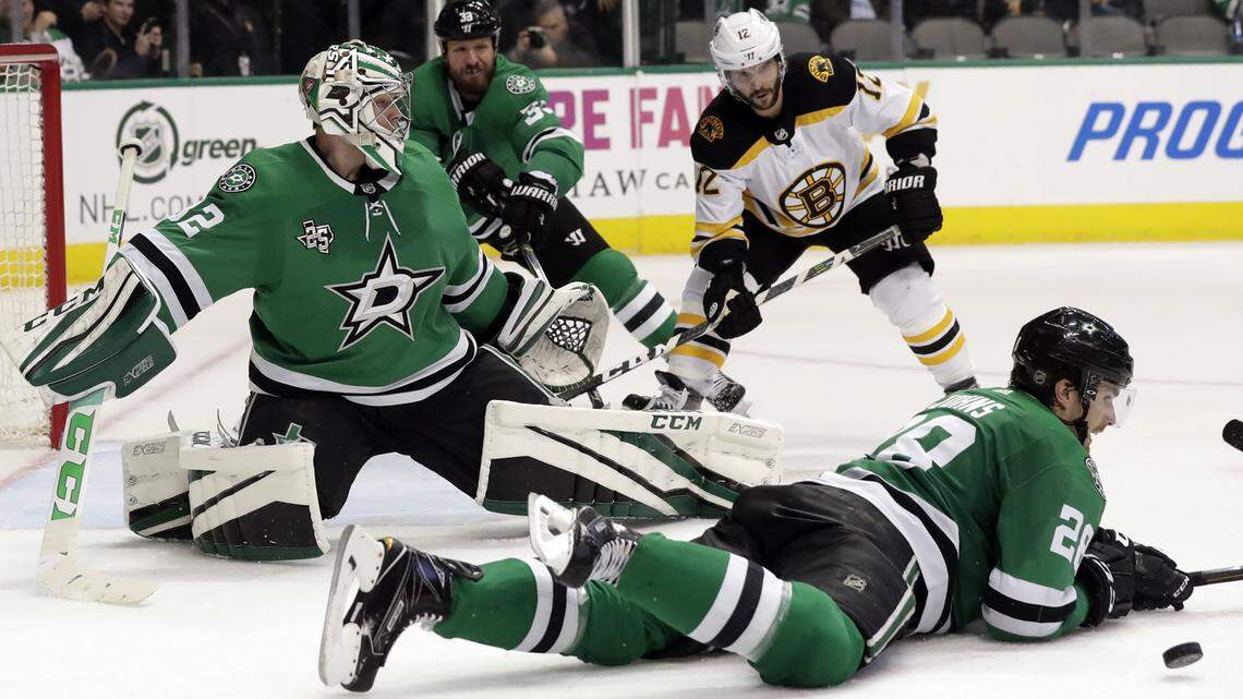 Dallas Stars defenseman Stephen Johns (28) lays down to block a shot from the Boston Bruins as goalie Kari Lehtonen (32), defenseman Marc Methot (33) and the Bruins' Brian Gionta (12) watch in the second period of Friday's game in Dallas. Boston won 3-2.