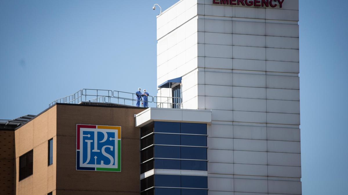 JPS Hospital employees watch for the Blue Angels flyover as a tribute to frontline healthcare workers in May 2020. The public hospital previously operated 15 clinics on or near Tarrant County schools that closed in 2021.