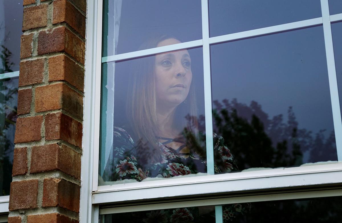 Fort Worth resident Haley Forsyth looks out the window of her home on Wednesday, May 1, 2024. Forsyth said she was scammed out of $60,000 from her neighbor, Robert Rambo, after signing a promissory note to flip three vehicles in late 2023. Through her digging, Forsyth learned others had similarly lost money through Rambo. Forsyth is planning on selling her home because of the emotional toll it’s taken on her and her family.
