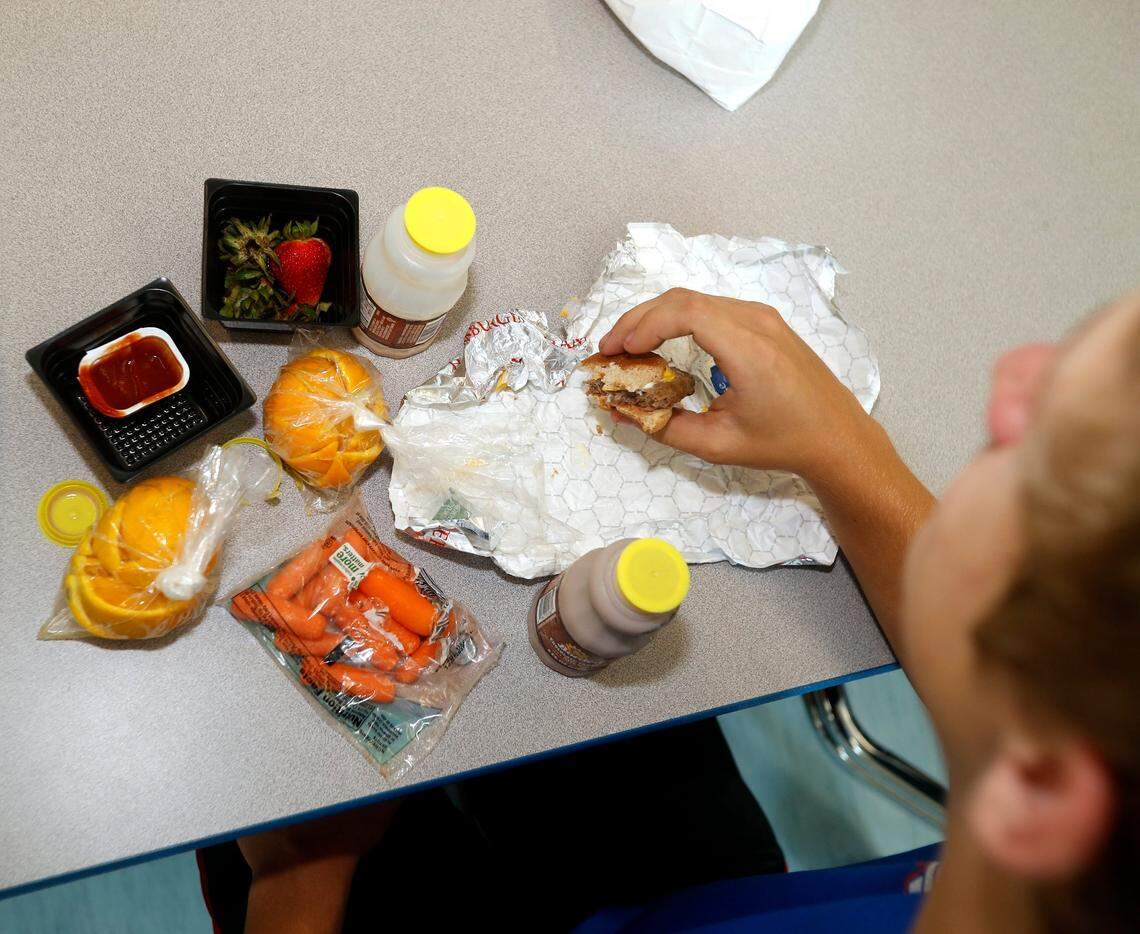 A high school athlete at Amon Carter Riverside High School takes advantage of a free summer meal after working out in the weight room.