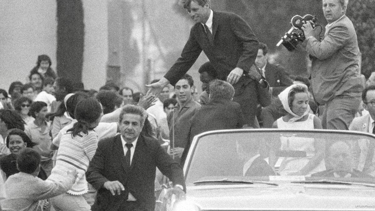 Political advance man Jerry Bruno clears the way for Sen. Robert F. Kennedy at a campaign appearance in Oxnard, California, June 1, 1968.