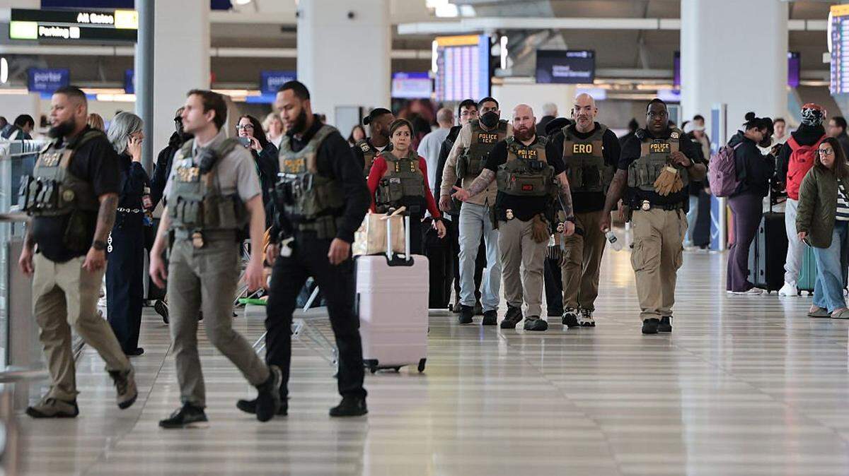 ICE agents patrol Terminal B at LaGuardia Airport on March 23, 2026, in New York City. The travel disruptions continue as hundreds of TSA agents quit or work without pay during a partial government shutdown. U.S. President Donald Trump said ICE agents will be deployed to U.S. airports on Monday, with border czar Tom Homan in charge of the effort.