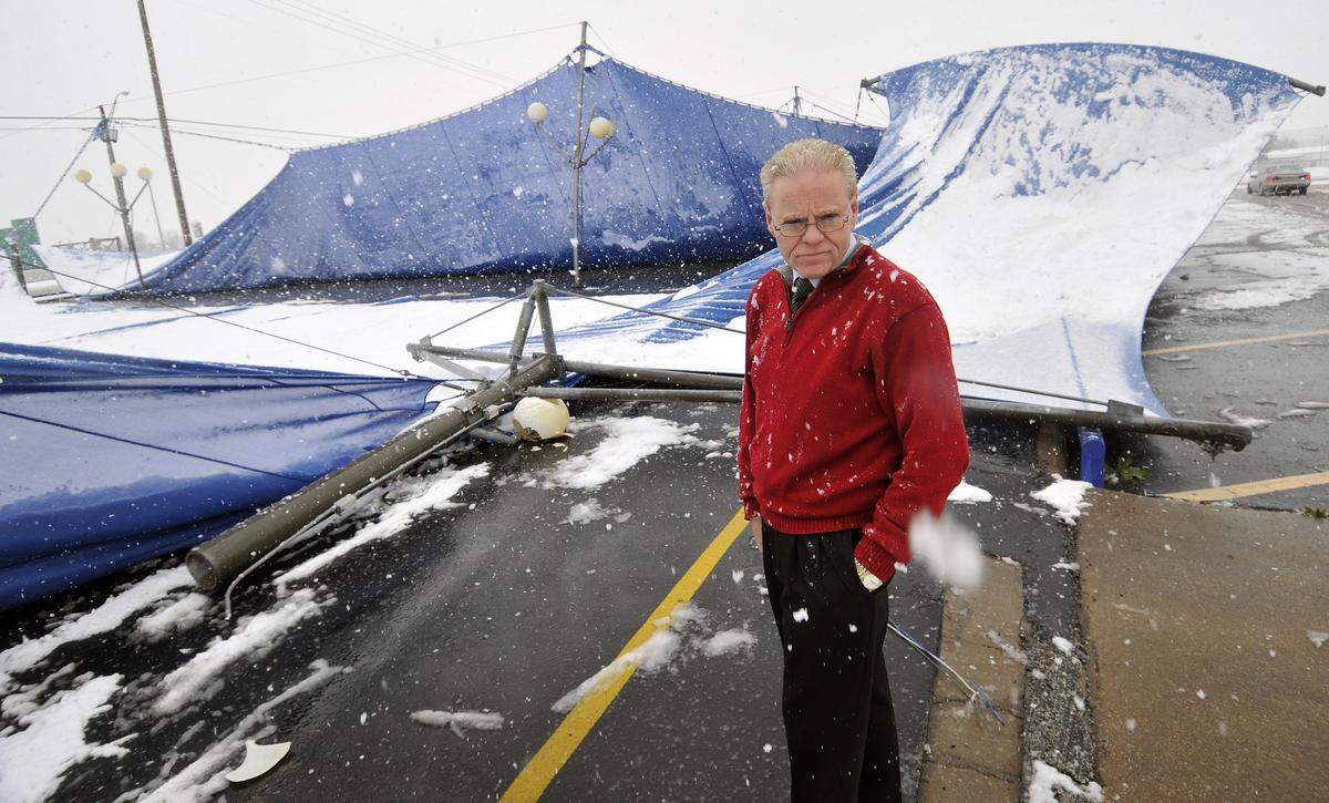 Chip Jones, general sales manager at Bruce Lowrie Chevrolet, surveys the damage to one of the awnings that collapsed today under the weight of the snow in Fort Worth, Thursday, February 11, 2010