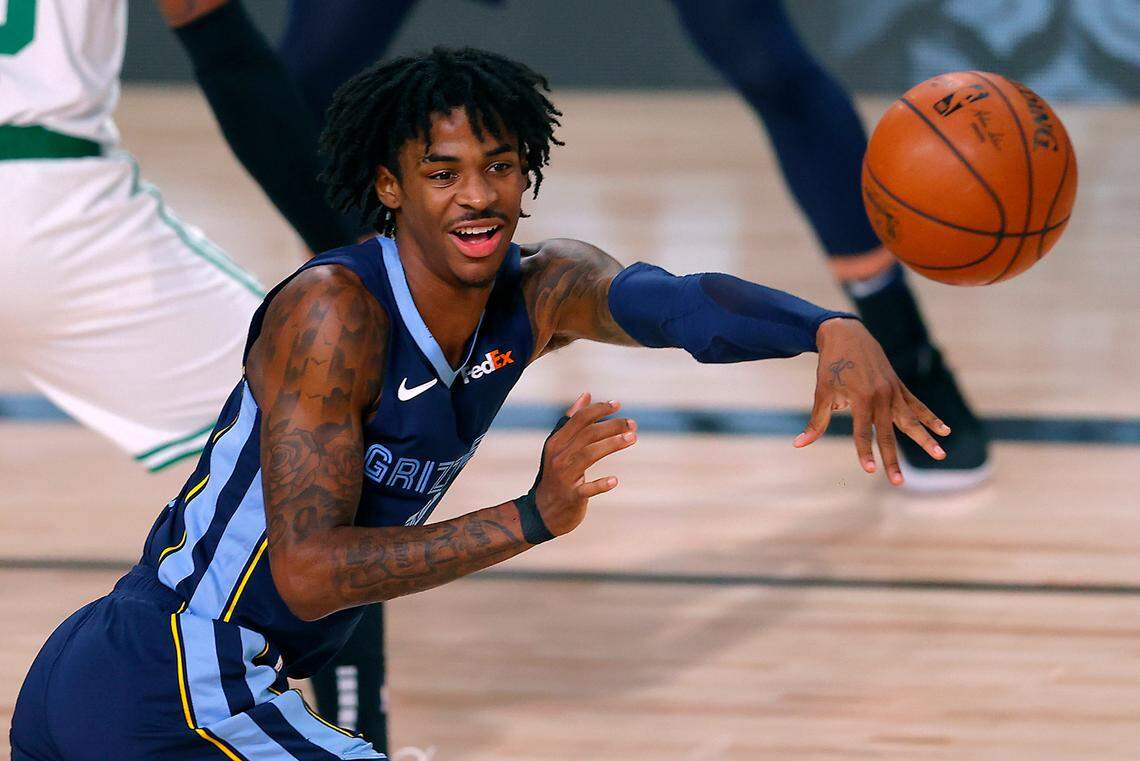 FILE - In this Aug. 11, 2020, file photo, Memphis Grizzlies’ Ja Morant passes the ball during the second half of an NBA basketball game against the Boston Celtics in Lake Buena Vista, Fla. Morant was announced Wednesday, Sept. 2, 2020, as the winner of the Rookie of the Year award for 2019-20, the first Grizzlies player to win the award since Pau Gasol in 2001-02. (AP Photo/Mike Ehrmann, Pool, File)