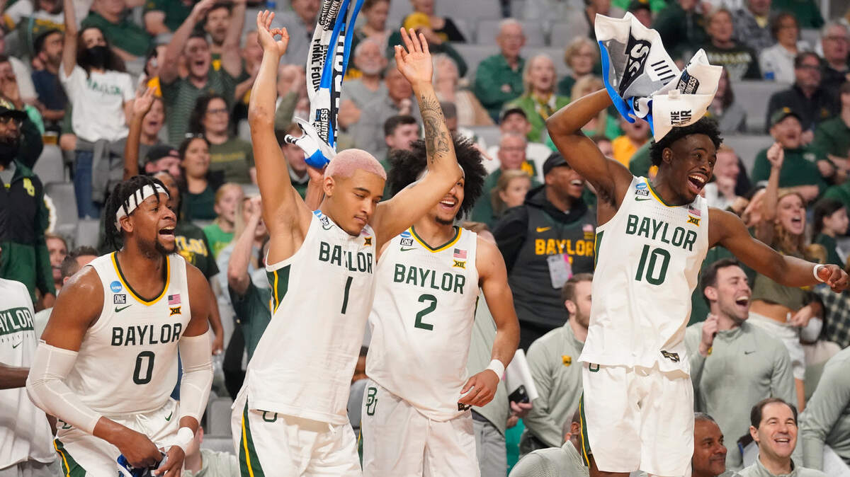 Baylor players, from left, Flo Thamba, Jeremy Sochan, Kendall Brown, and Adam Flagler celebrate on the bench during late in Thursday’s 85-49 win against Norfolk State at Dickies Arena in Fort Worth. The No. 1 seed Bears (28-6) advanced to play the No. 8 seed North Carolina Tar Heels (26-9) at 11:10 a.m. Saturday in the NCAA Tournament’s second round.