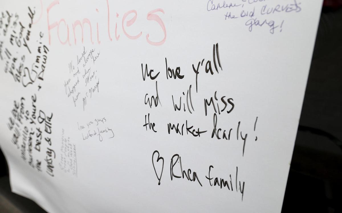 Community members leave messages of support on a poster board outside of Burleson’s independent grocery store City Market on Wednesday, Feb. 5, 2025. The store will close this month.