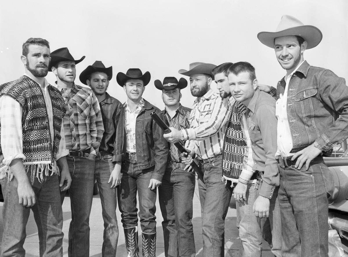 March 21, 1958: TCU Ranch Week “sheriff” O’Neal Nelson, holding a shotgun, called his deputies together Friday morning to find the jail. It was stolen a few minutes earlier. From left are Charles Johnson, Ronnie Etheridge, Frank Schlicht, Wallie Simpson, Bobbie Mueller, sheriff Nelson, Phil McGauhy, Ed Barry and George Irvin.