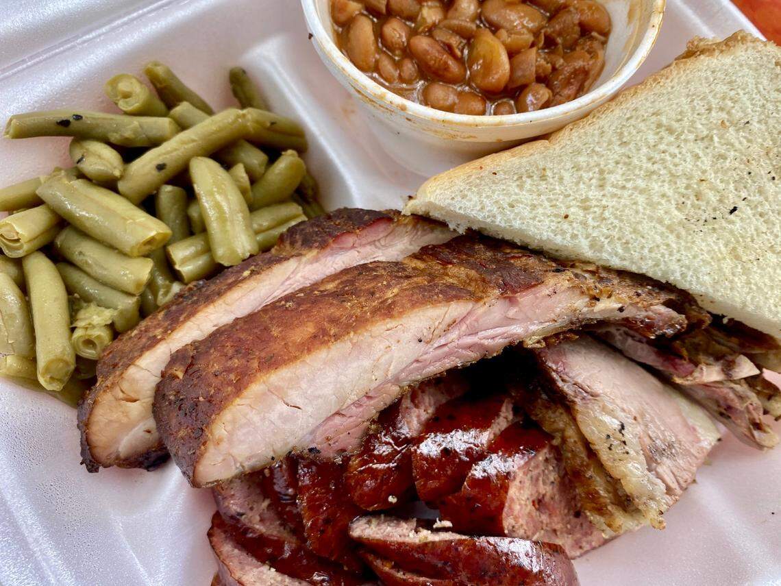 A combo plate from Off The Bone BBQ in Forest Hill with ribs, sausage and brisket.