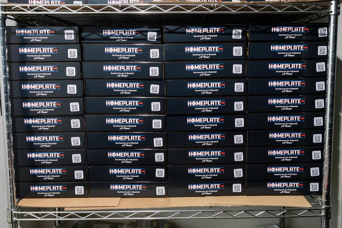 Boxes of the Homeplate USA baseball board game are stacked on each other in Miguel Otero’s apartment while being prepped to send to customers nationwide.