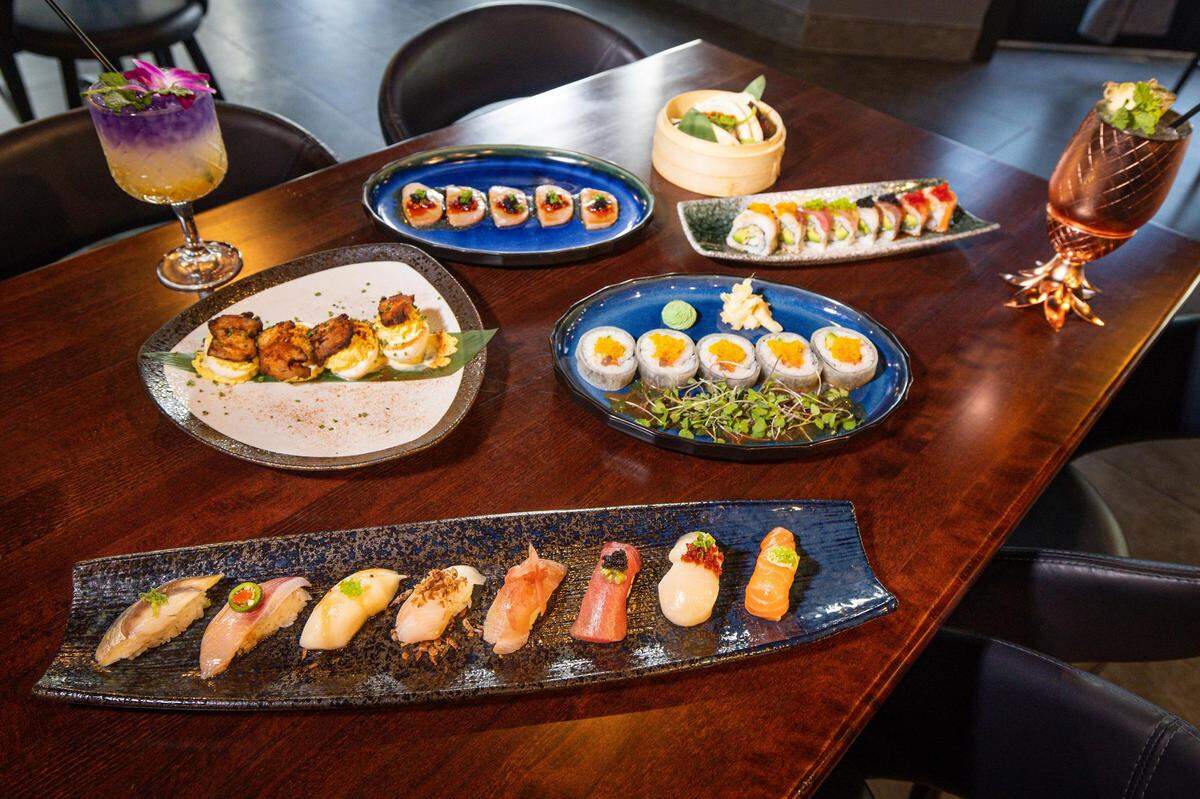 Assorted dishes including the Nigiri Sampler, the Pork Belly Deviled Eggs, the Hush Hush Roll, the Truffle Kanpachi, the Hush Rainbow Roll, and the BaoBao along with mixed drinks including the Purple Mango, left, and the Pineapple Mojito from Hush Sushi, Kitchen and Bar in Keller, Texas on Thursday, Aug. 24, 2023.
