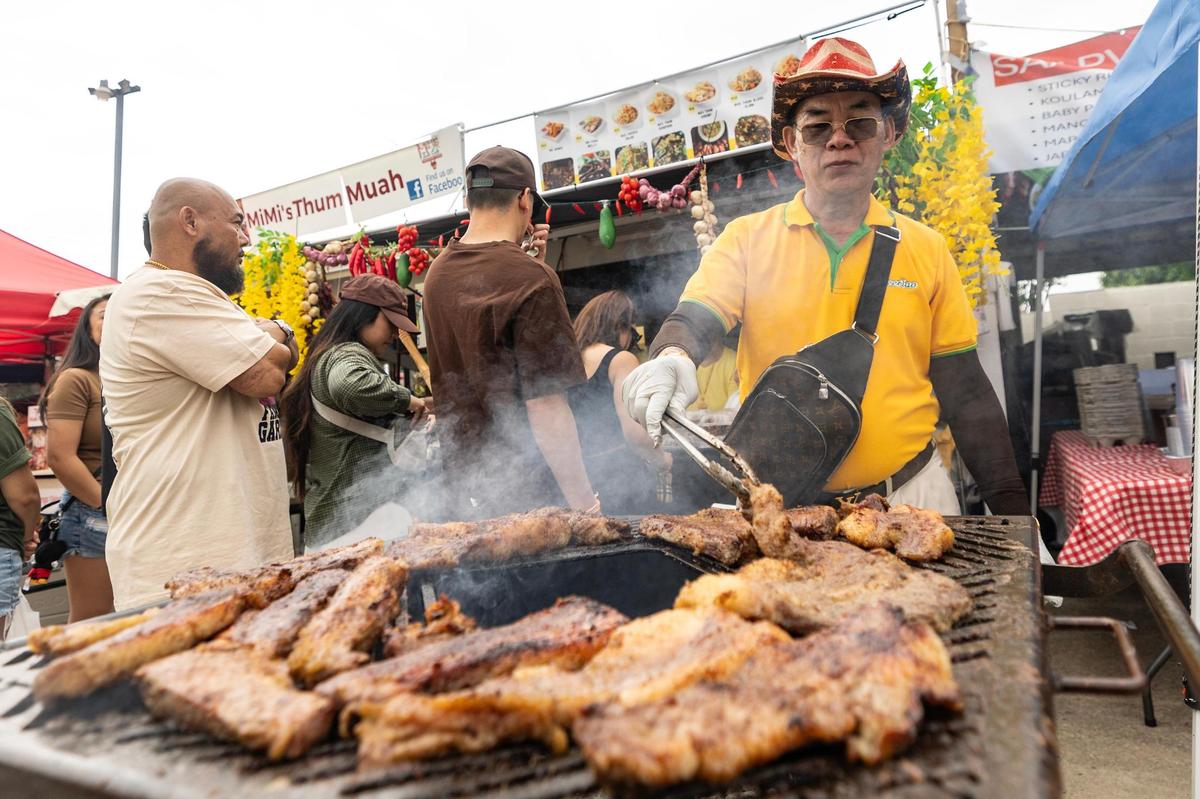 Bounthone Nakhone of Asiannights Lao-Thai Cuisine cooks the Lao Brisket on the grill on the third day of the Lao New Year festival at Wat Lao Thepnimith Temple in Saginaw on Sunday, April 27, 2025.