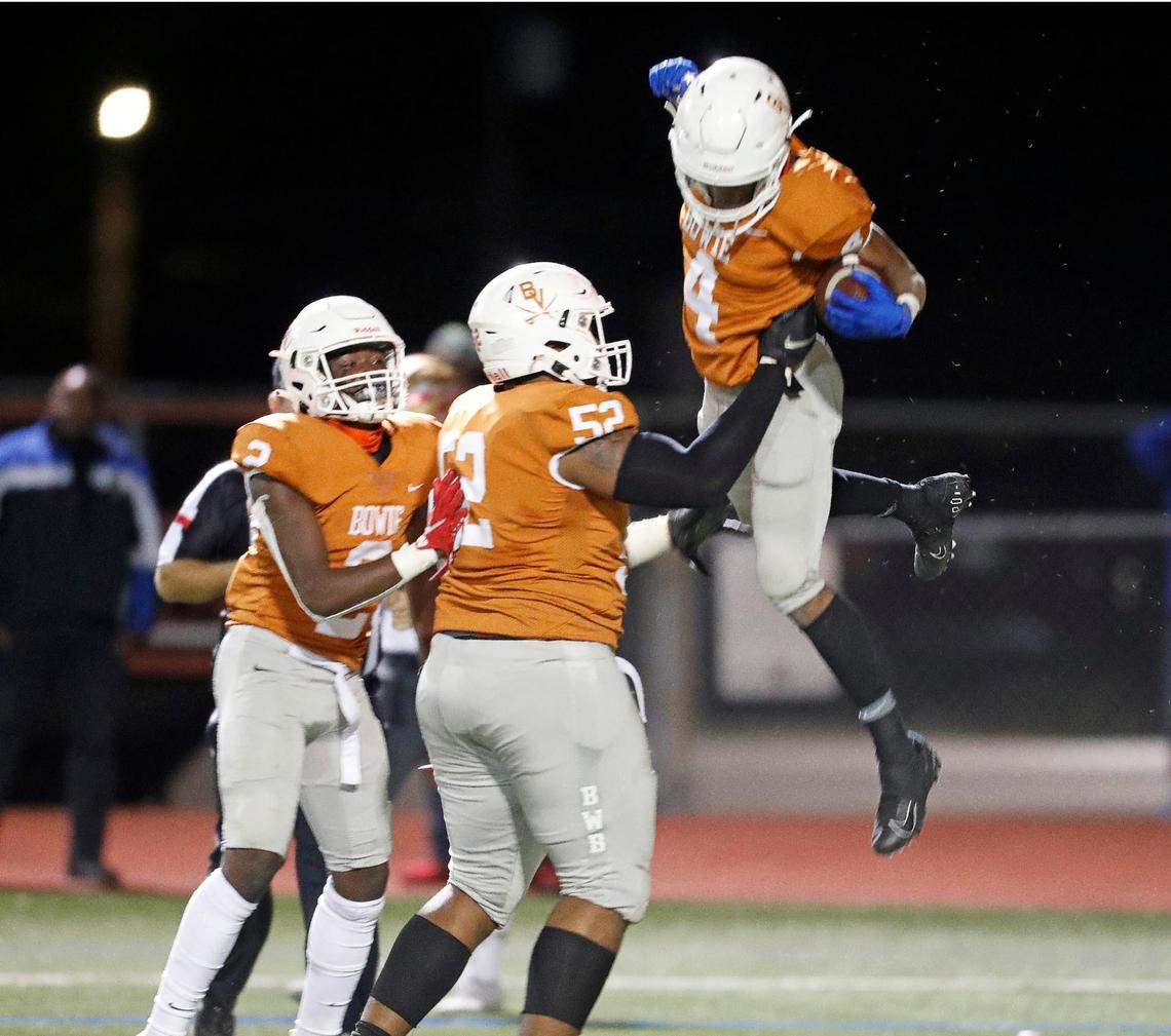 Bowie offensive lineman Devon Campbell (52) lifts wide receiver Trint Scott (4) after Scott scored the go-ahead touchdown during a high school football game at Wilemon Field in Arlington, Texas, Thursday, Oct. 15, 2020. Bowie defeated South Grand Prairie 28-14. (Special to the Star-Telegram Bob Booth)