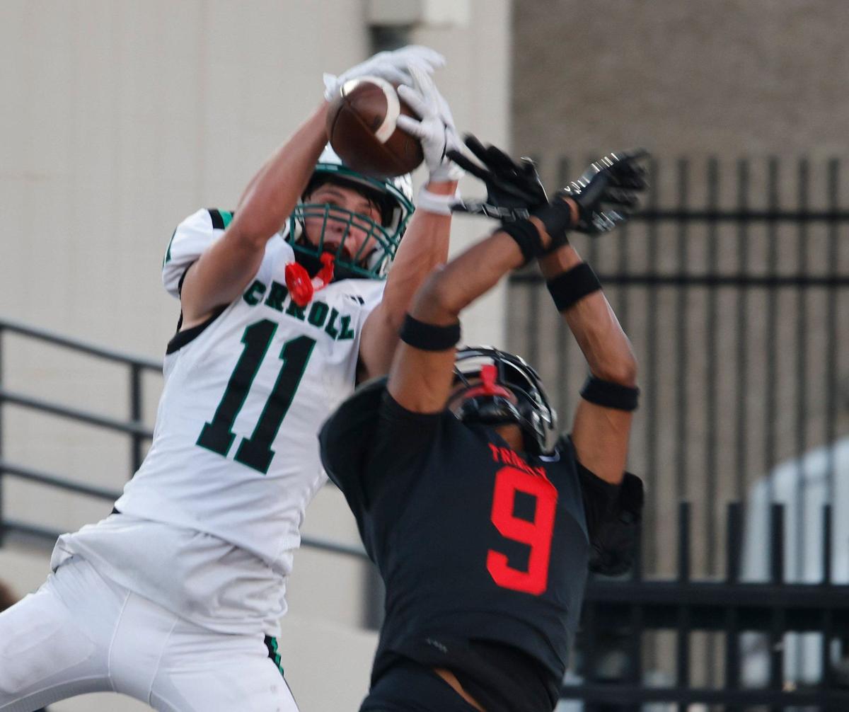 Southlake wide receiver Brock Boyd (11) grabs a pass defended by Trinity defensive back John Meredith (9) during a UIL 6A Conference football game at Pennington Field in Bedford Texas, Friday, Sept. 20, 2024.
