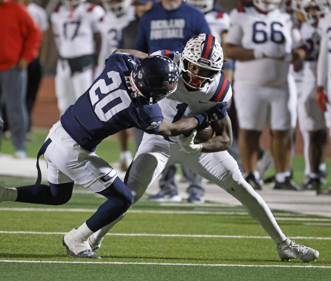 Denton Ryan defensive back Temperance Epps (20) brings down Richland running back Jayshon Gibson (1) after a short gain during the first half of a UIL Class 5A Division I Regional on Friday Nov. 28, 2025 at Buddy Echols Field in Coppell, Texas.