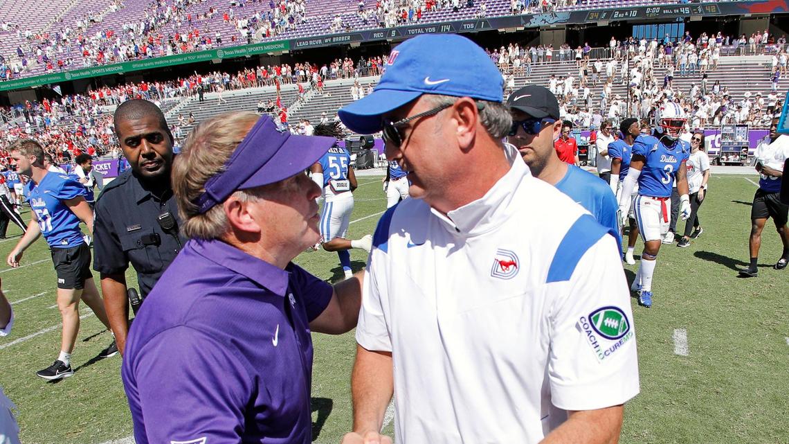 TCU coach Gary Patterson, left, congratulates SMU counterpart Sonny Dykes after the Mustangs’ win Saturday in Fort Worth. SMU defeated TCU 42-34 to retain the Iron Skillet for another year.