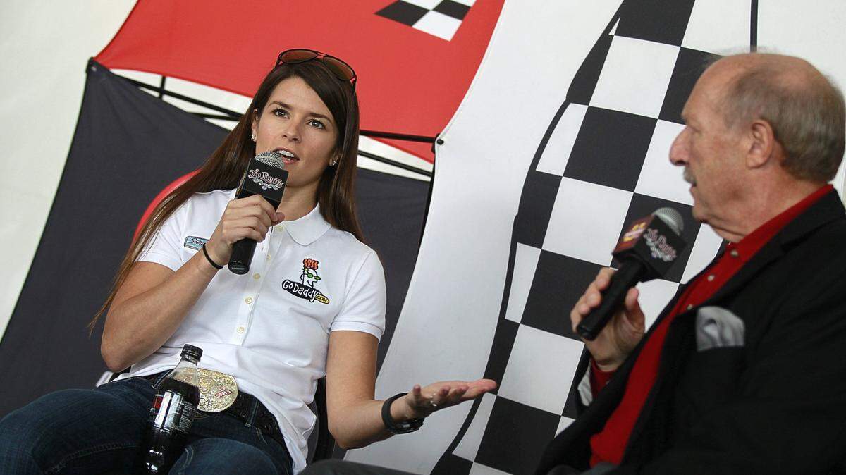 Sportsradio 1310 The Ticket host Norm Hitzges (right) announced his retirement on Thursday. He worked on the DFW airwaves for 48 years. Here he sits with former NASCAR and IndyCar driver Danica Patrick in 2012.
