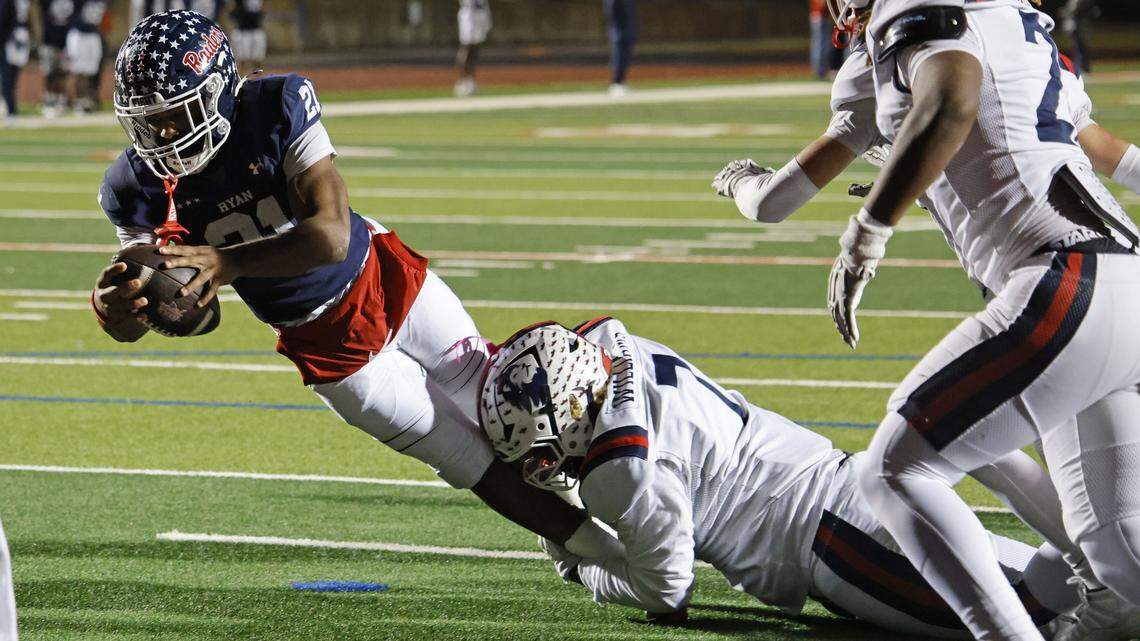 Denton Ryan running back Rontavian Brown (21) stretches to the end zone for a touchdown against Richland during the second half of a Class 5A Division I regional playoff Friday at Buddy Echols Field in Coppell.