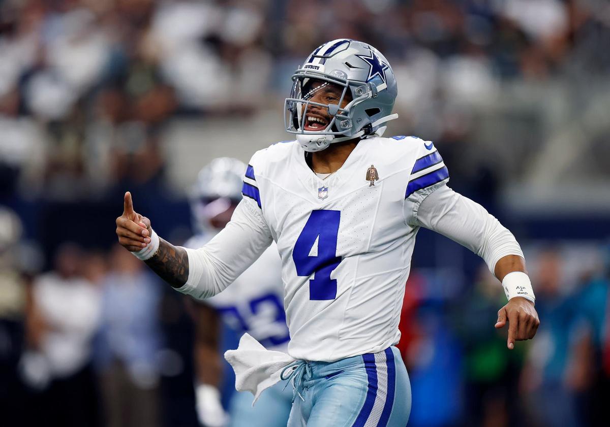 Cowboys quarterback Dak Prescott celebrates after connecting with wide receiver CeeDee Lamb in the first quarter against the New Orleans Saints on Sept. 15, 2024, at AT&T Stadium.