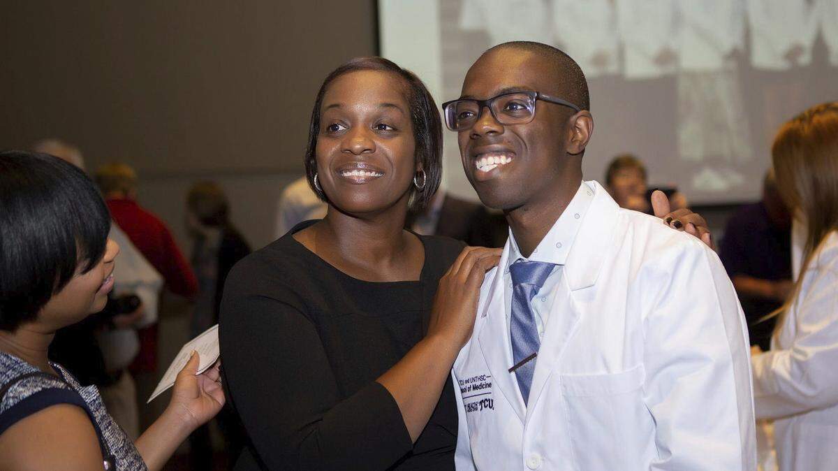 Brandon Mallory, a student at TCU and UNTHSC School of Medicine, and his mom Amanda Mallory celebrate his white coat ceremony in July 2019.
