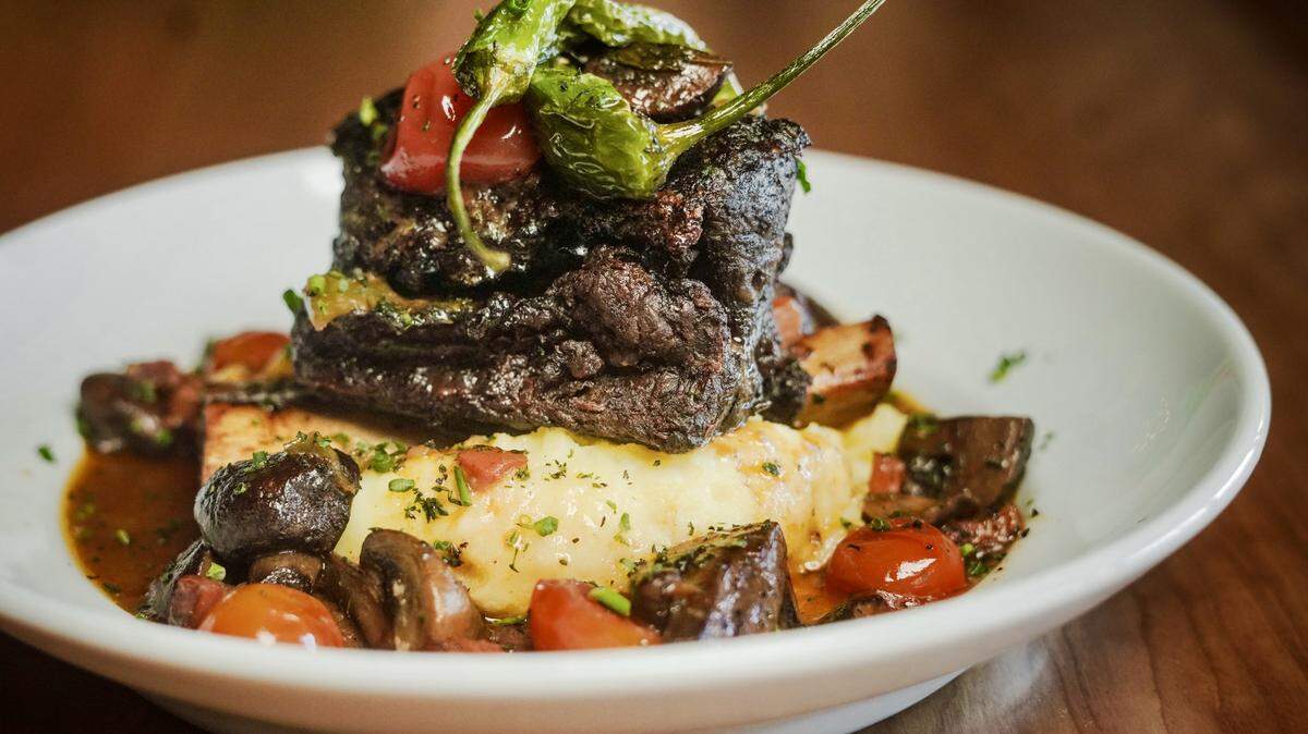Short ribs over mashed potatoes with shishito peppers and a smoked bacon-mushroom sauce at Rex’s Bar & Grill.