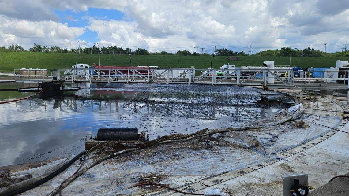 Contractors clean crude oil from a tank at the Village Creek Wastewater Treatment Plant on May 8, 2025.