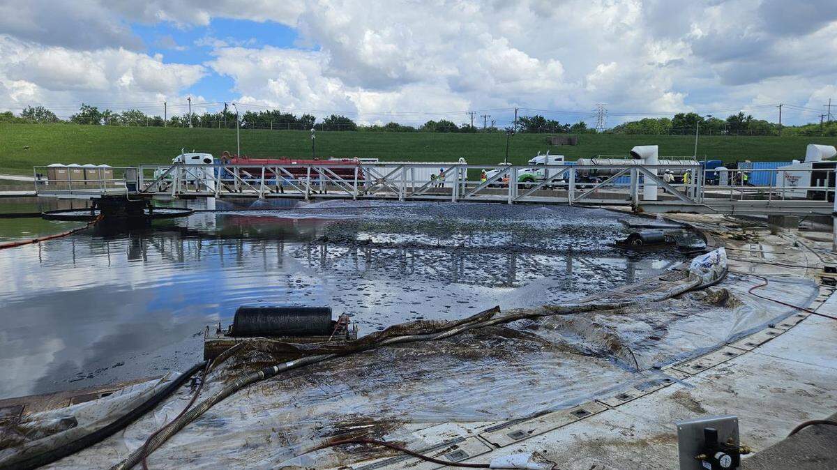 Environmental contractors clean crude oil from a tank at the Village Creek Wastewater Treatment Plant on May 8, 2025.