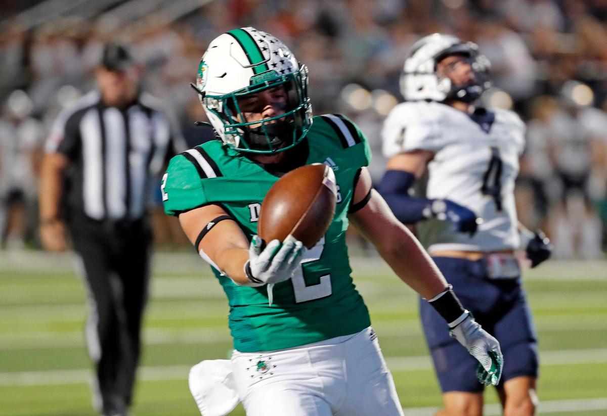 Southlake Carroll running back Owen Allen (2) presents the ball after he scores in the first half of a District 4-6A high school football game at Dragon Stadium in Southlake, Texas, Friday, Oct. 07, 2022. Keller led Carroll by four at the half. (Special to the Star-Telegram Bob Booth)
