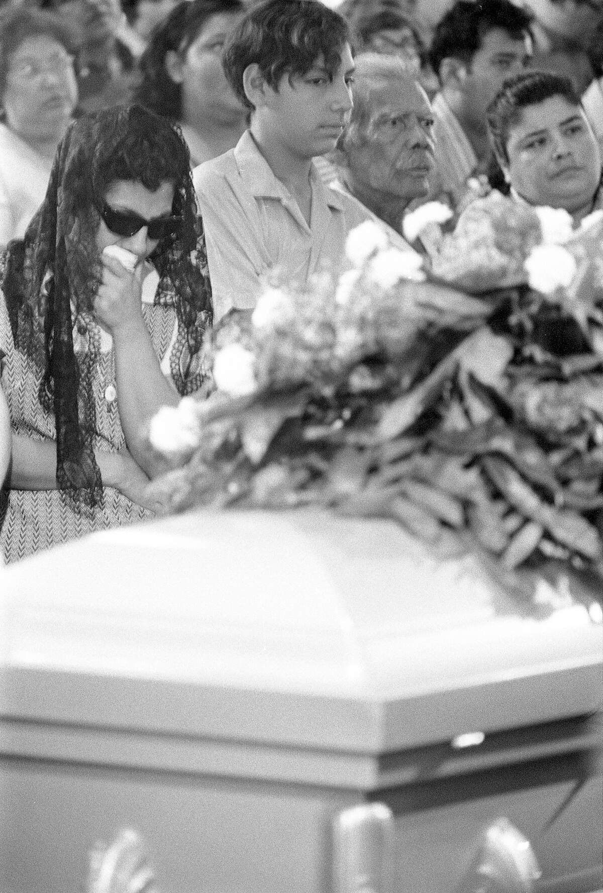 Bessie Rodriguez, David Rodriguez, and Carlos Minez, along with family and community mourners, attend Santos Rodriguez’s funeral on July 26, 1973.