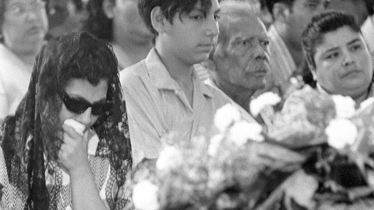 Bessie Rodriguez, David Rodriguez, and Carlos Minez, along with family and community mourners, attend Santos Rodriguez’s funeral on July 26, 1973.