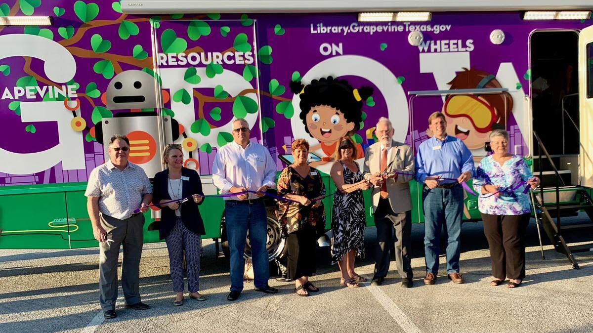 Officials celebrate with a ribbon cutting to unveil the GROW (Grapevine Resoures on Wheels) vehicle, the city’s first mobile library.