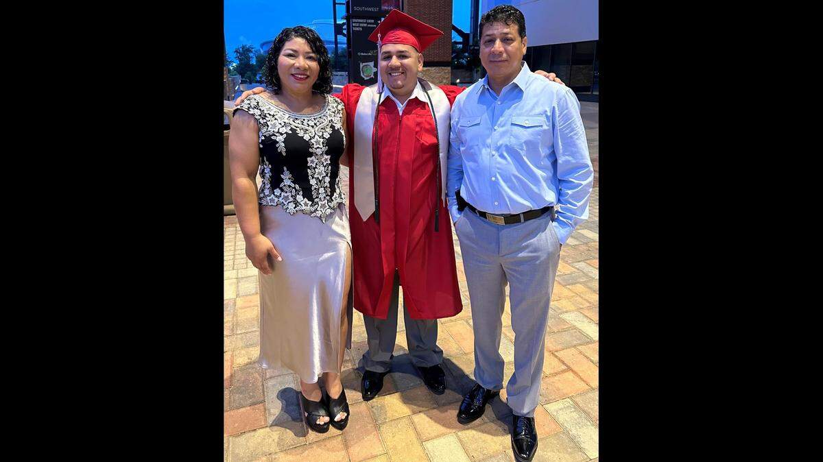 Misael Rico Jr., center, at his high school graduation. Rico was 6 years old when a distracted driver hit him near his Irving elementary school, his mother said in a new TxDOT ad campaign.