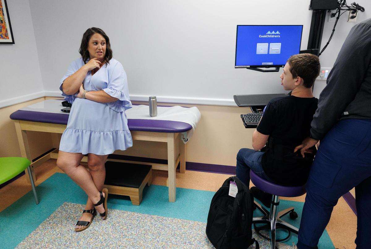Meghan Czarobski, left, looks over at her son Preston Benjaman-Sewell during an appointment at Cook Children’s Dodson Specialty Clinics in June.