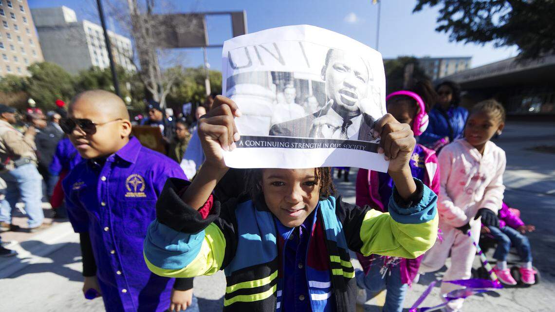 A young marcher participates in the Martin Luther King day parade in Fort Worth, Monday, January 15, 2018.