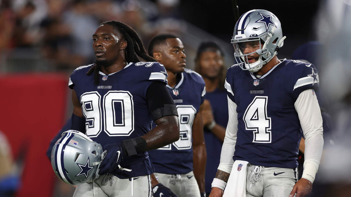 DeMarcus Lawrence, left, and the Dallas Cowboys defense has a friendly wager against Dak Prescott, right, and the offense. The units are betting whether the defense forces more turnovers than the offense scores touchdowns for the rest of the season, including last week’s win against the Giants.