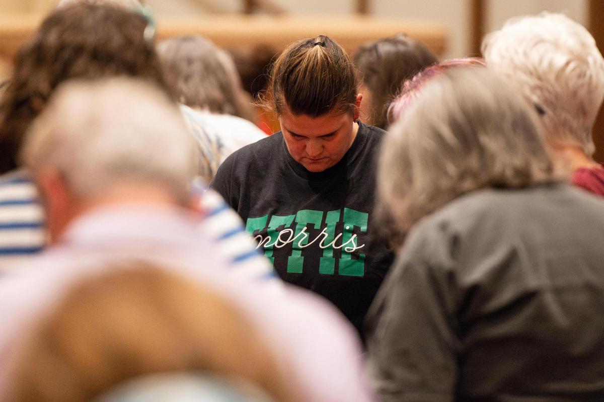 Lake Worth ISD teacher Rebekah May bows her head in prayer with the other meeting attendees during the Pastors for Texas Children Town Hall Call to Action at Arlington Heights United Methodist Church in Fort Worth on Wednesday, April 9, 2025.