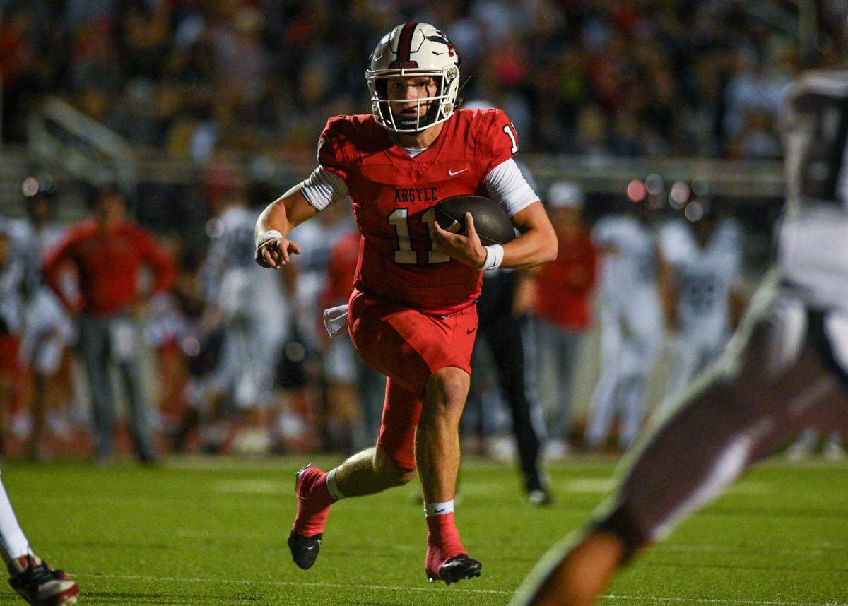 Argyle quarterback Maguire Gasperson (11) runs toward the end zone during a UIL football game against Colleyville Heritage at Eagle Stadium in Argyle, Texas on Friday, Sept. 27, 2024.