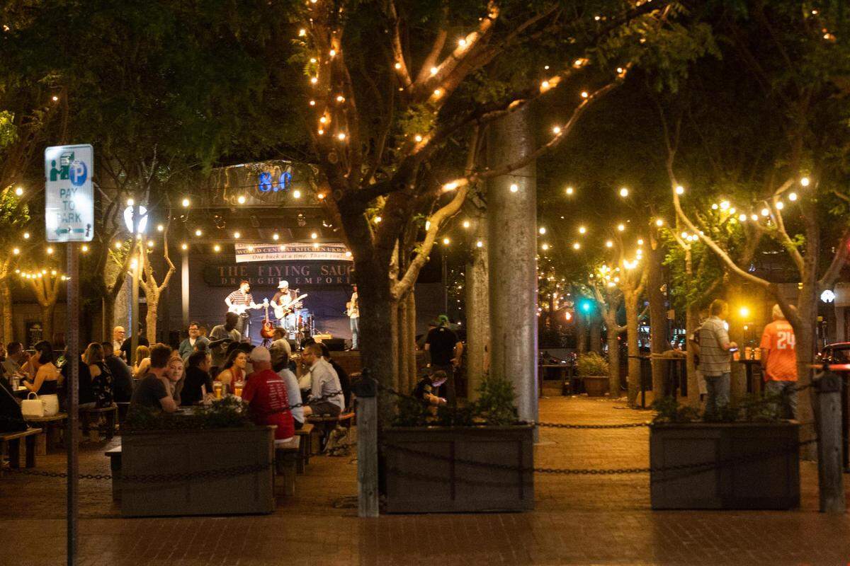 People listen to a band playing at Flying Saucer on Saturday, May 7, 2022, in downtown Fort Worth.