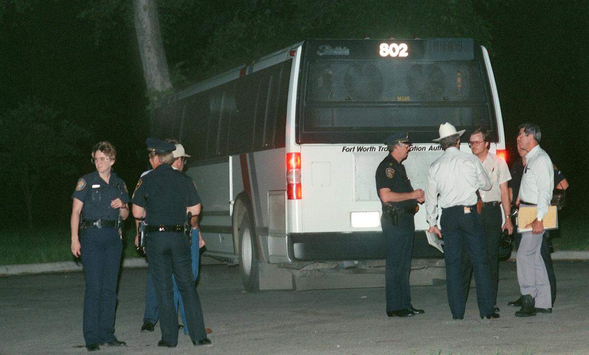 Fort Worth police check a hijacked bus for evidence after it was abandoned in Trinity Park west of downtown Fort Worth.