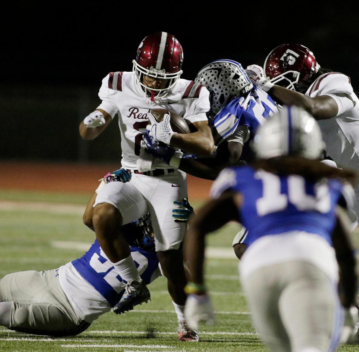 Red Oak’s Lorenzo Holman is wrapped up by the Burleson defense during a UIL football game at Burleson ISD Stadium on Friday October 25, 2024.